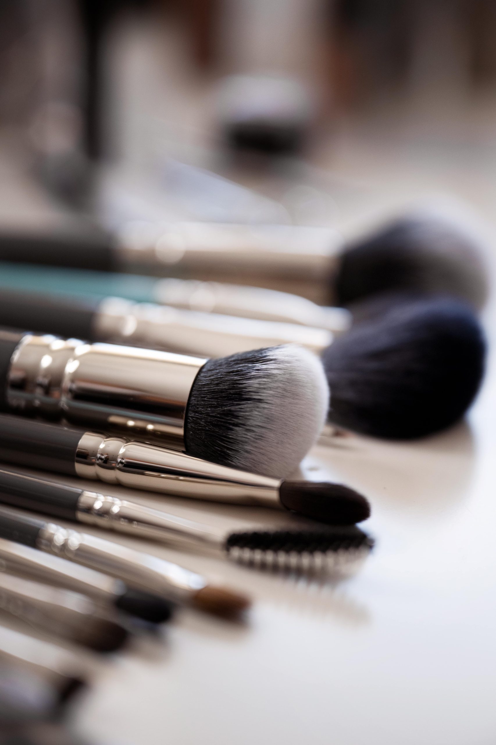 high-angle-makeup-brushes-arrangement-min